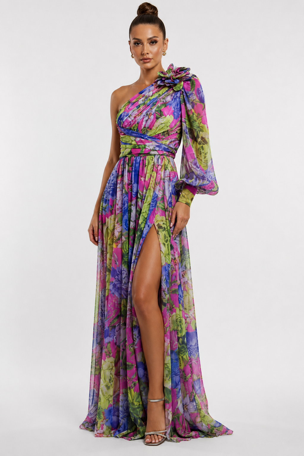 Woman wearing a colorful one-shoulder dress with a slit on a white background