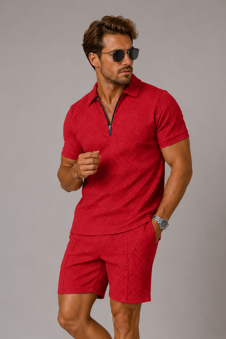Man wearing a red polo shirt and shorts with white sneakers on a gray background