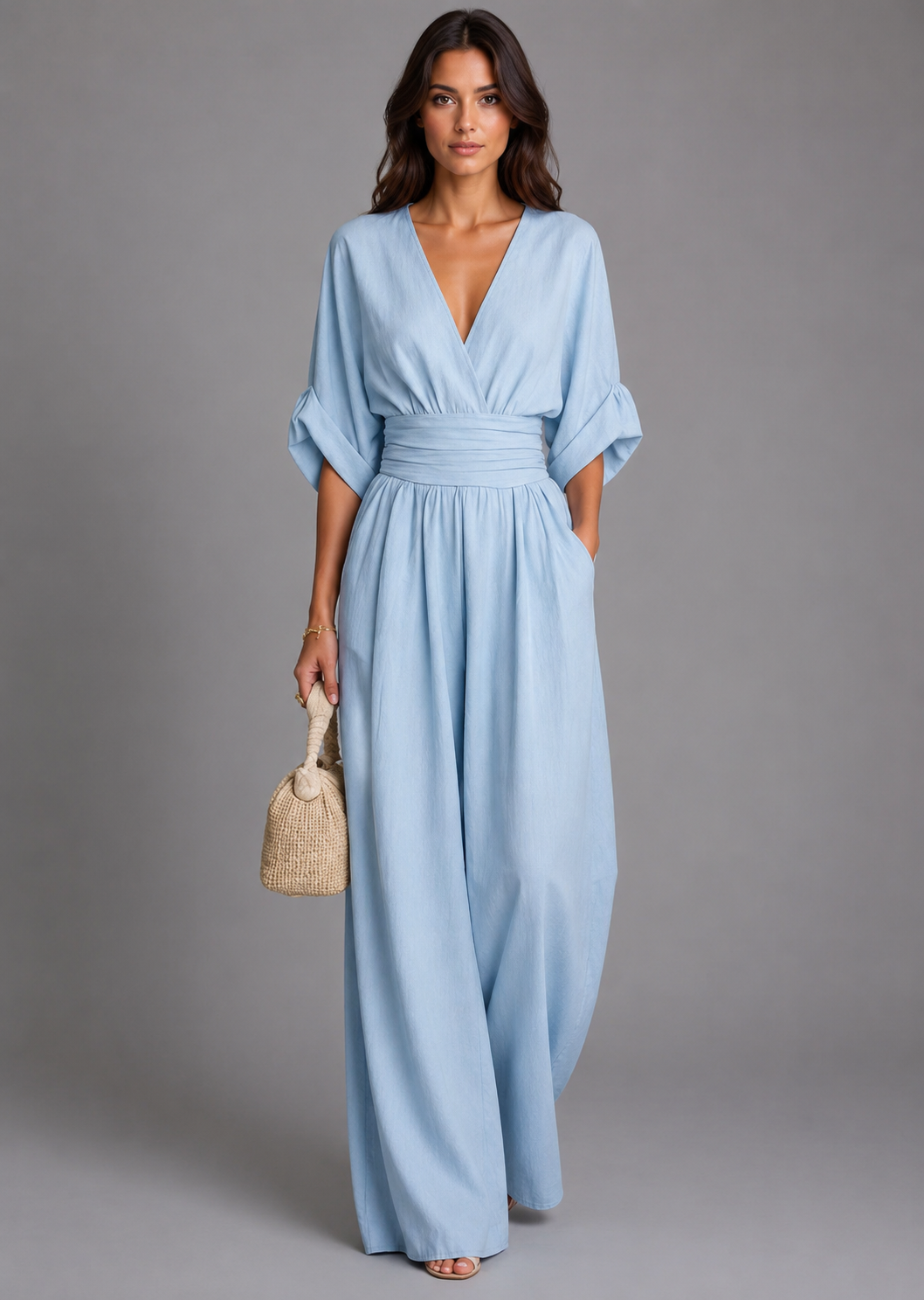 Woman wearing a light blue dress with a plain background