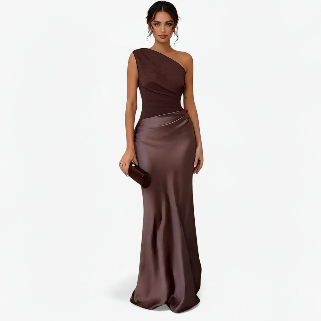 Women’s asymmetric maxi dress in brown with delicate pleats, flowing and elegant for weddings and formal events.
