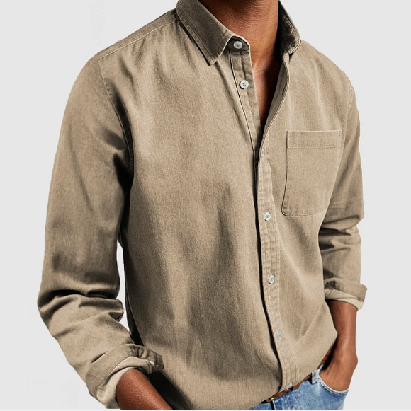 Beige button-up shirt worn by a person on a light gray background