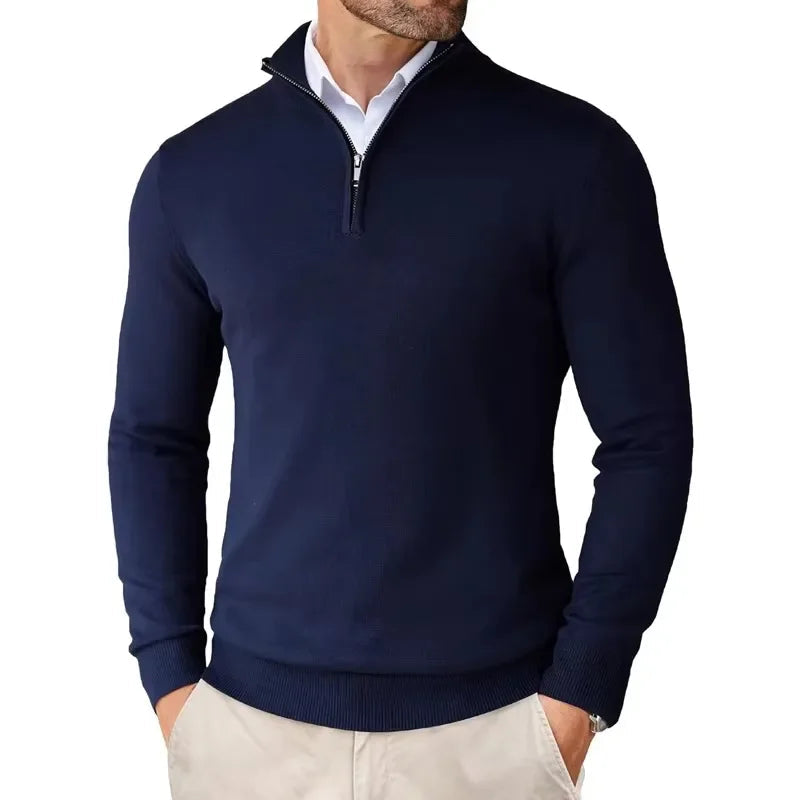 Navy blue quarter-zip sweater worn by a person on a white background