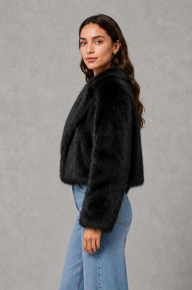 Women’s black faux fur coat with a soft plush texture, refined tailored silhouette and elegant finish for autumn and winter styling.