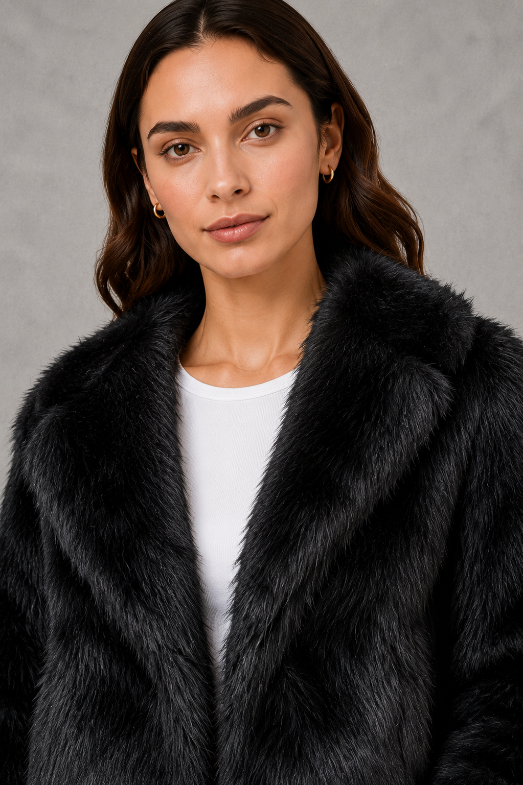 Women’s black faux fur coat with a soft plush texture, refined tailored silhouette and elegant finish for autumn and winter styling.