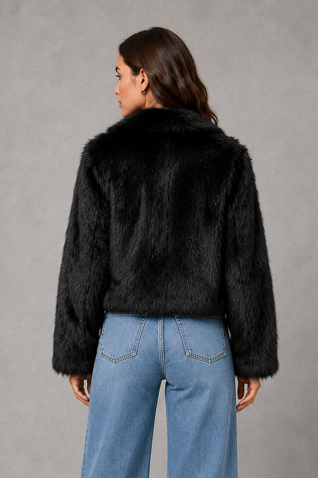 Women’s black faux fur coat with a soft plush texture, refined tailored silhouette and elegant finish for autumn and winter styling.