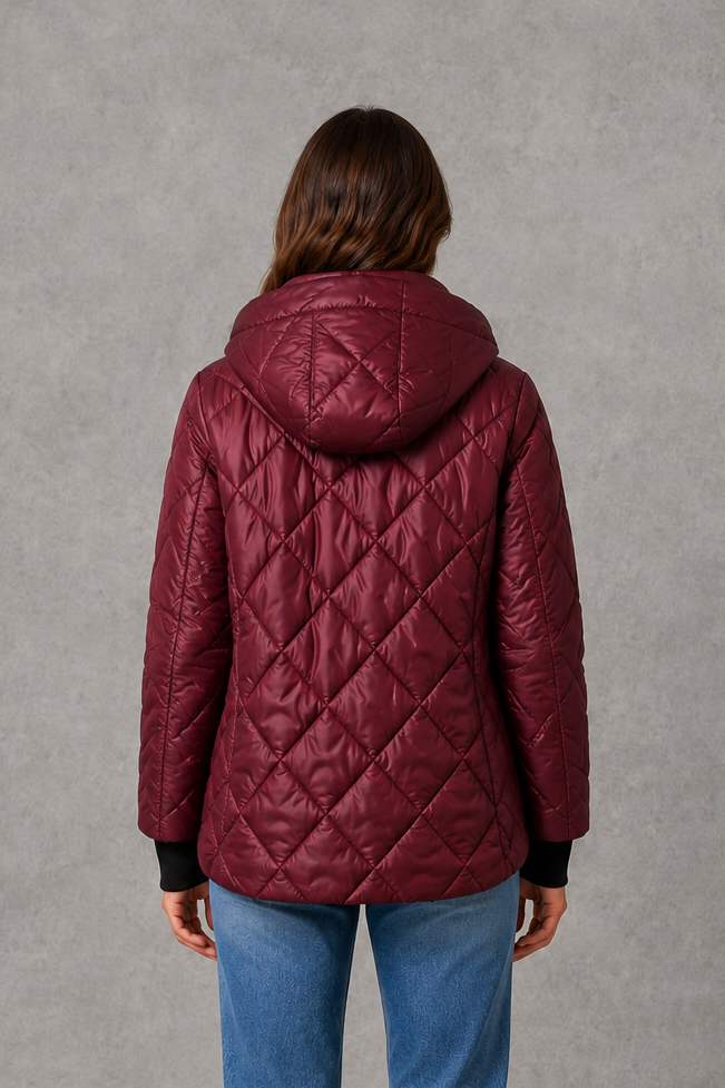 Women’s burgundy quilted puffer jacket with lightweight padding, a high collar, tailored silhouette and practical side pockets for winter wear.
