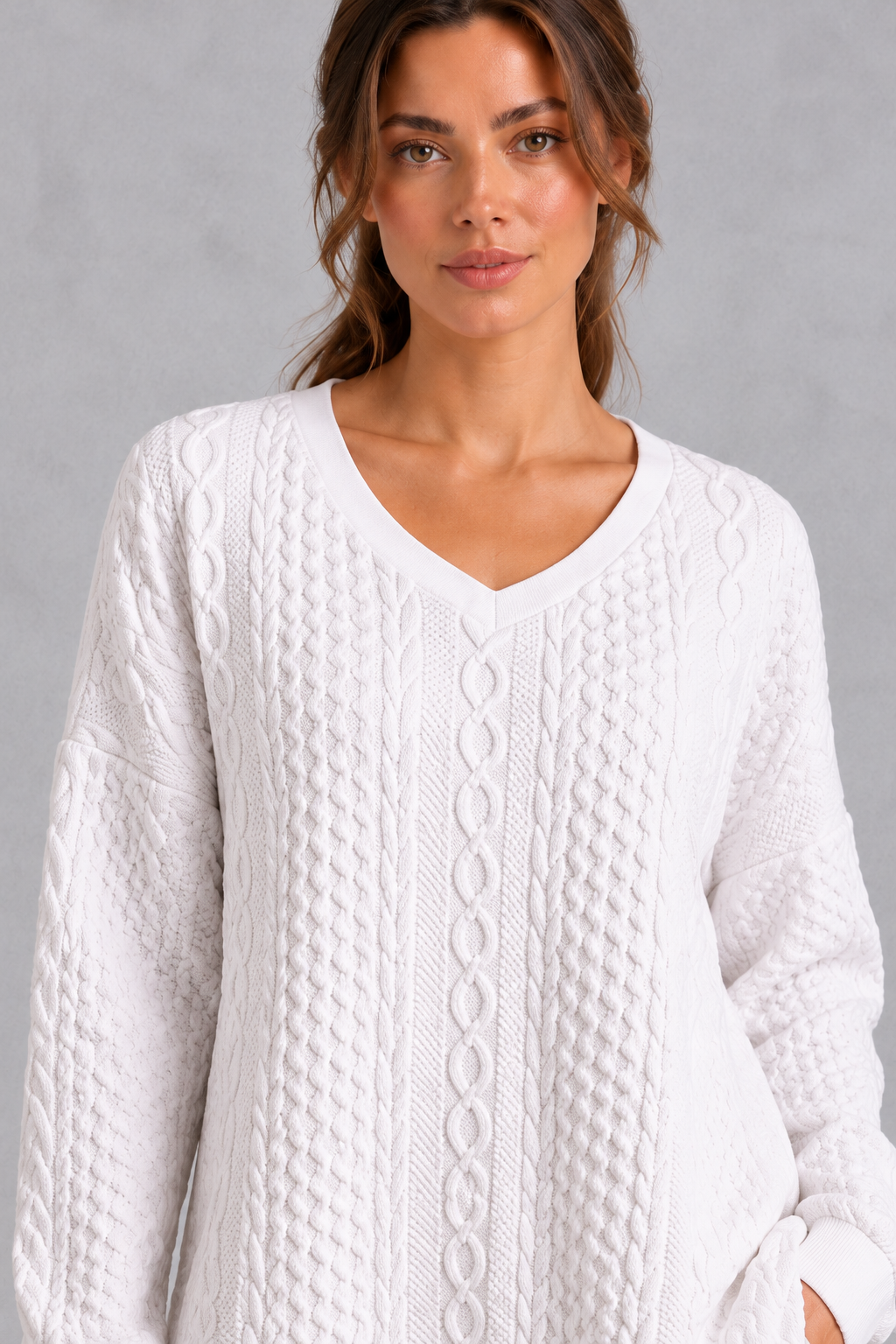 Women's white cable V-neck tunic jumper – close-up of V-neckline and cable knit texture