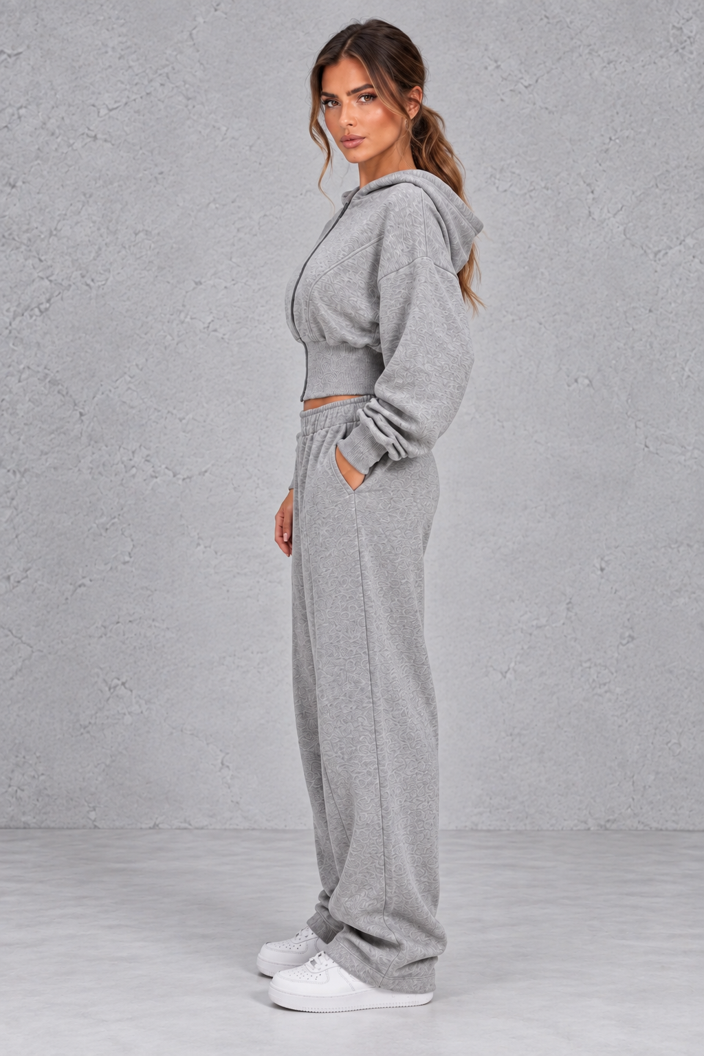 Shop this women’s cinched waist hoodie and wide leg jogger set with a relaxed fit and grey marl finish. Perfect for travel, lounging and casual everyday wear.