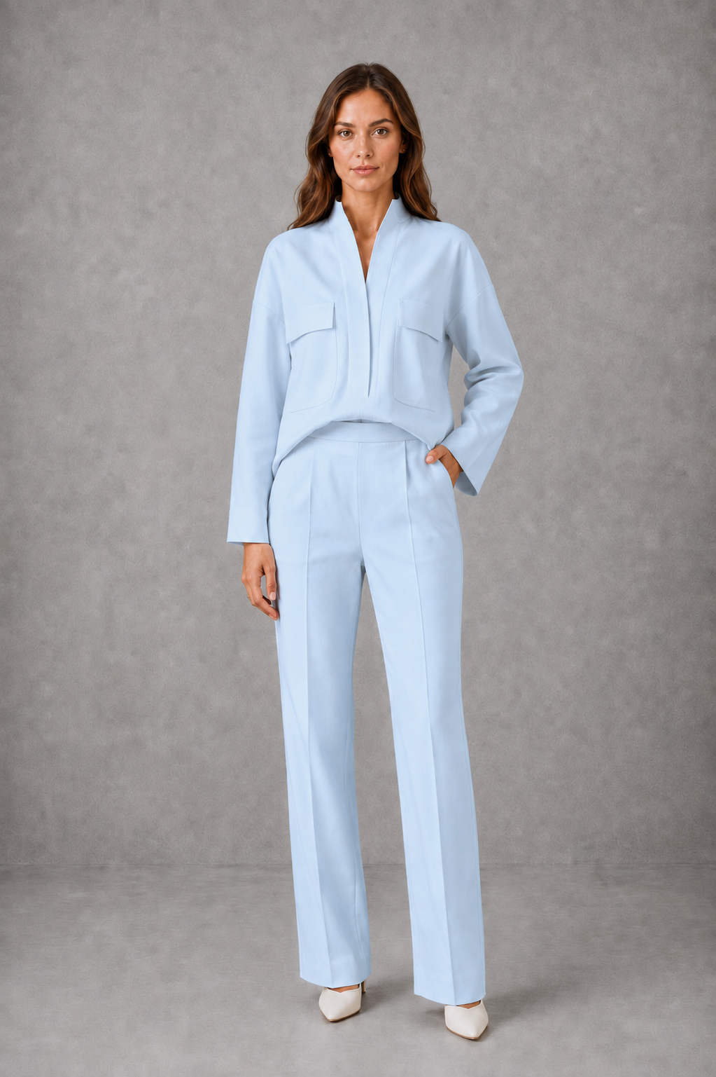 Women’s cropped V-neck jacket and high-waisted cigarette trouser two-piece set with chest patch pockets and a smart casual tailored silhouette.