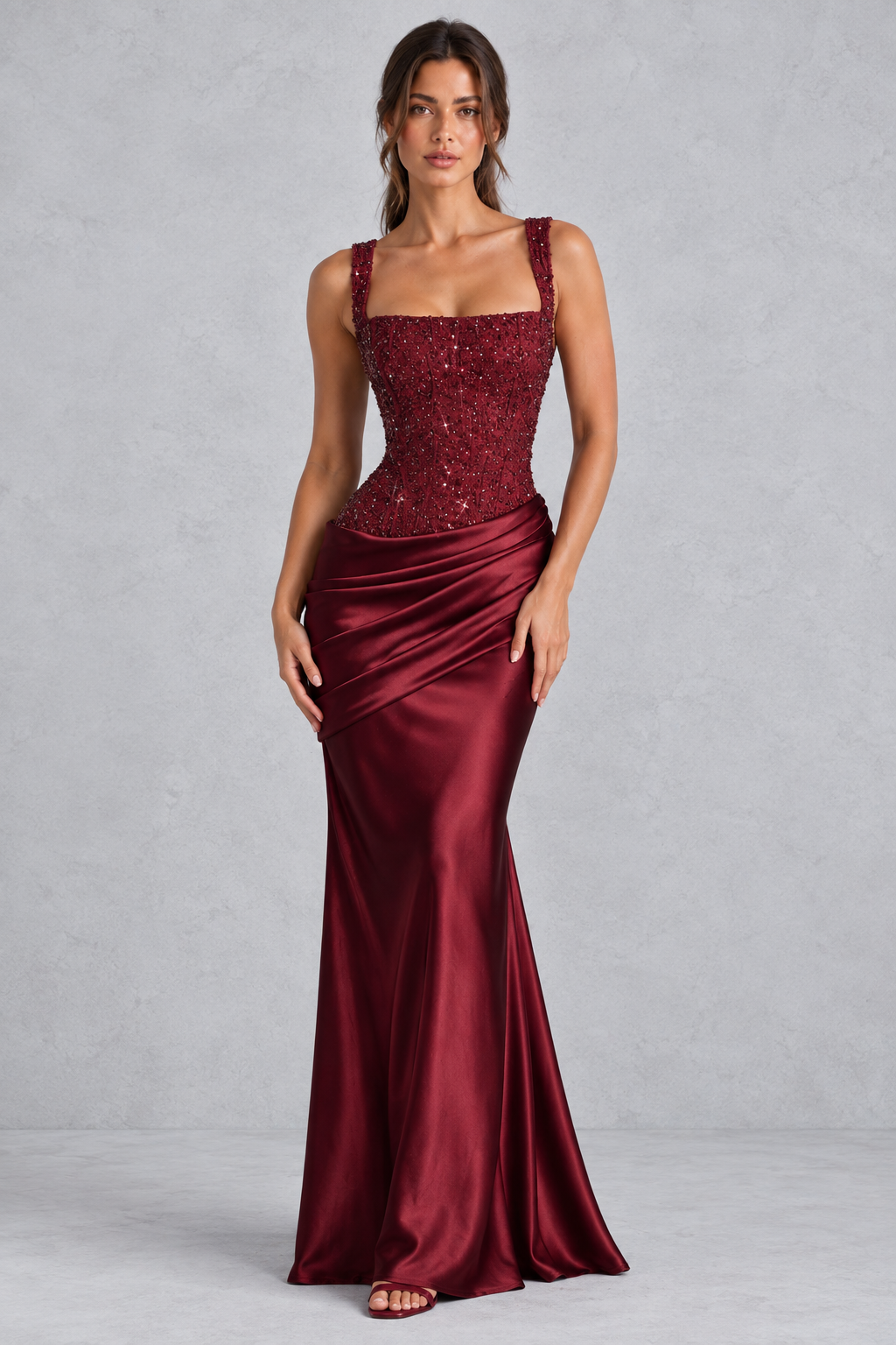 Women’s embellished corset satin maxi dress with square neckline, lace-up back, asymmetric pleated hip draping and flared hem.