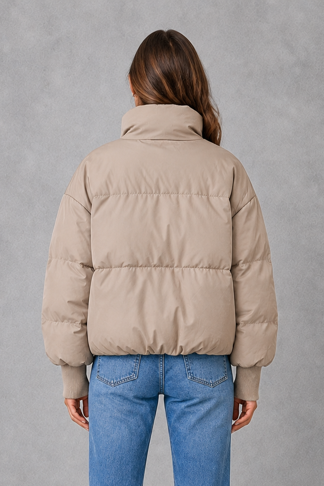 Women’s high collar quilted puffer jacket with lightweight padding, full zip fastening and practical side pockets for everyday winter wear.