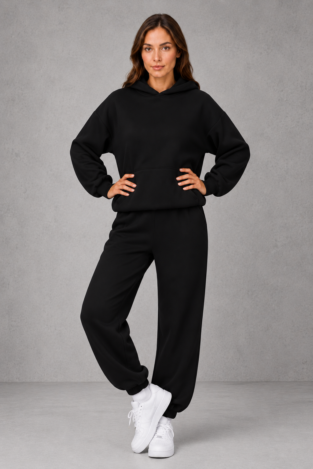 Women’s casual two piece tracksuit with relaxed drawstring hoodie and matching tapered cuffed joggers.