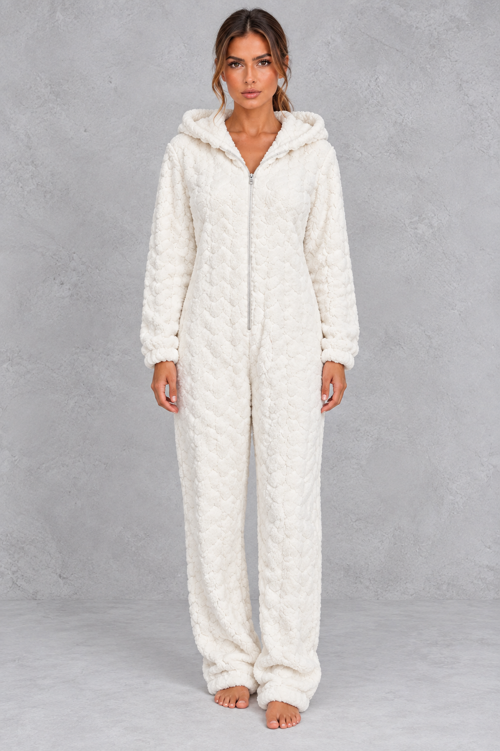 Women’s teddy fleece jumpsuit with a plush fluffy texture, large hood, full-length zip, long sleeves and relaxed one-piece silhouette.