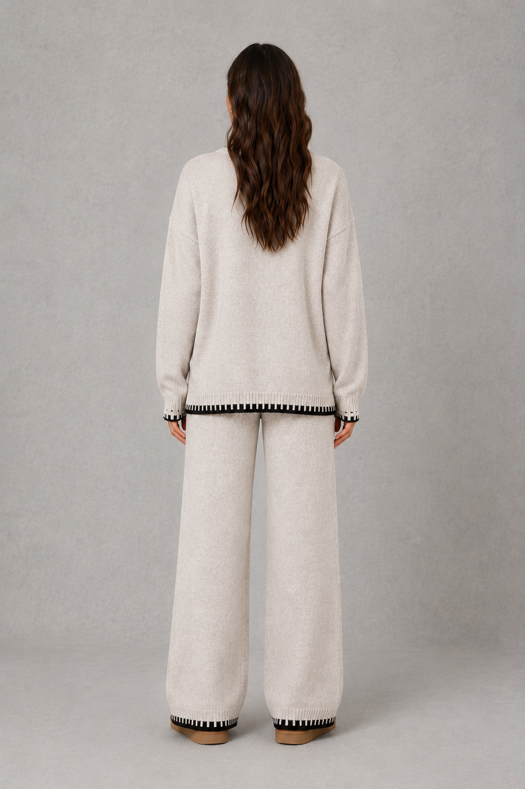 Women’s knitted co-ord set featuring a relaxed crew-neck jumper with contrast trim and matching wide leg knitted trousers.