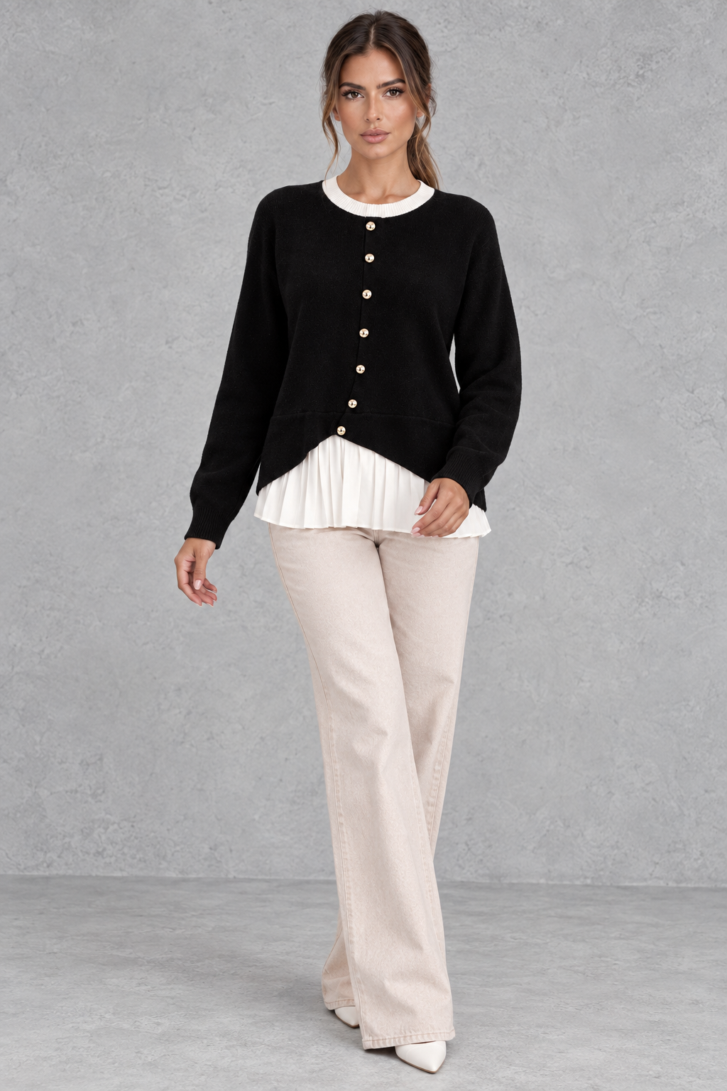 Women’s layered knit cardigan with a crew neckline, gold-tone button front, long sleeves and contrasting white pleated shirt-style hem.