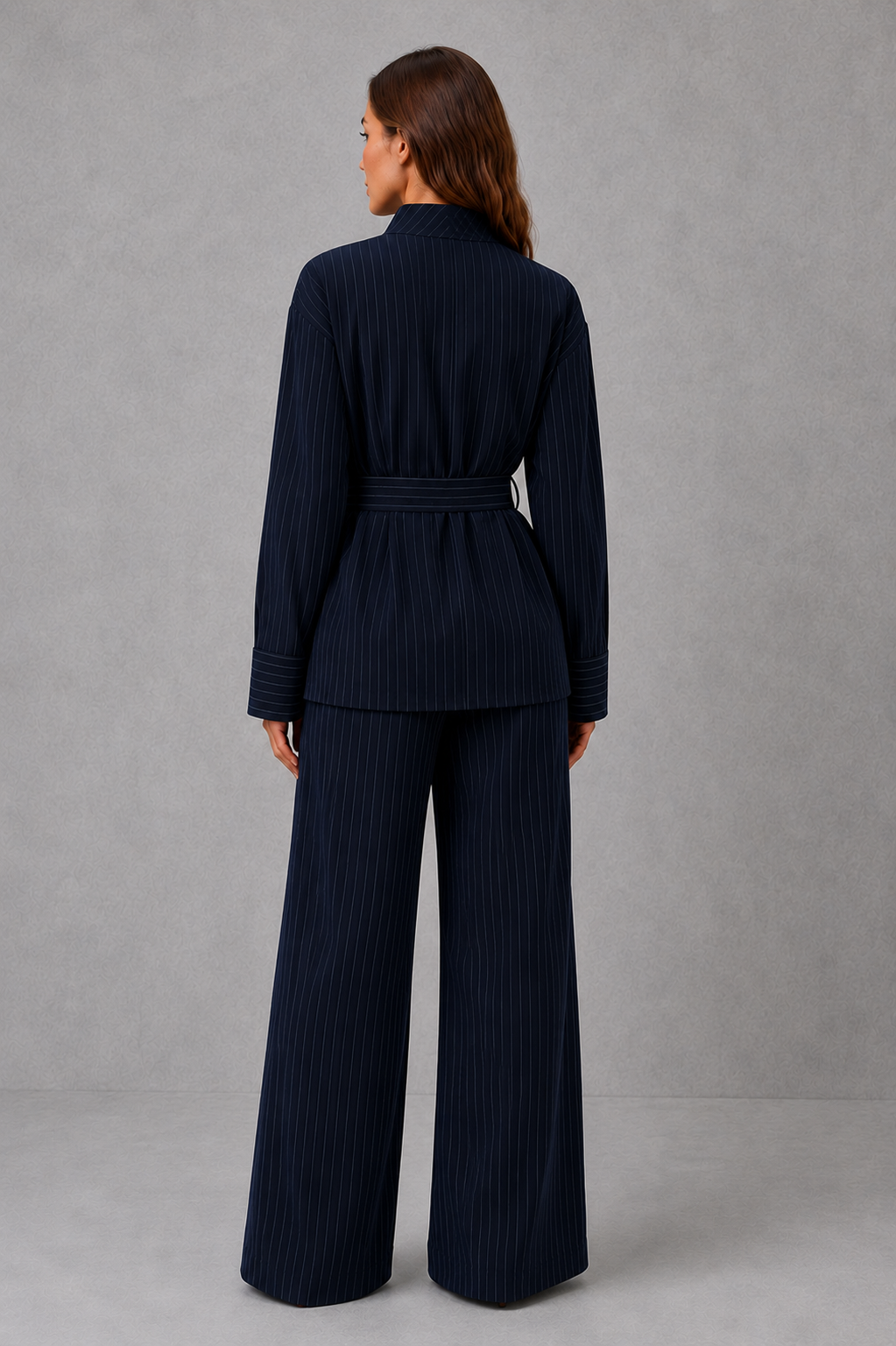 Women’s navy pinstripe two piece set with belted high neck long-sleeve top and matching wide leg palazzo trousers.