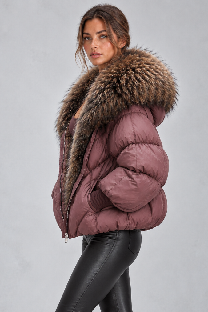 Women’s oversized puffer jacket with a plush faux fur-trimmed hood, voluminous padding, dropped shoulders and extended ribbed cuffs.