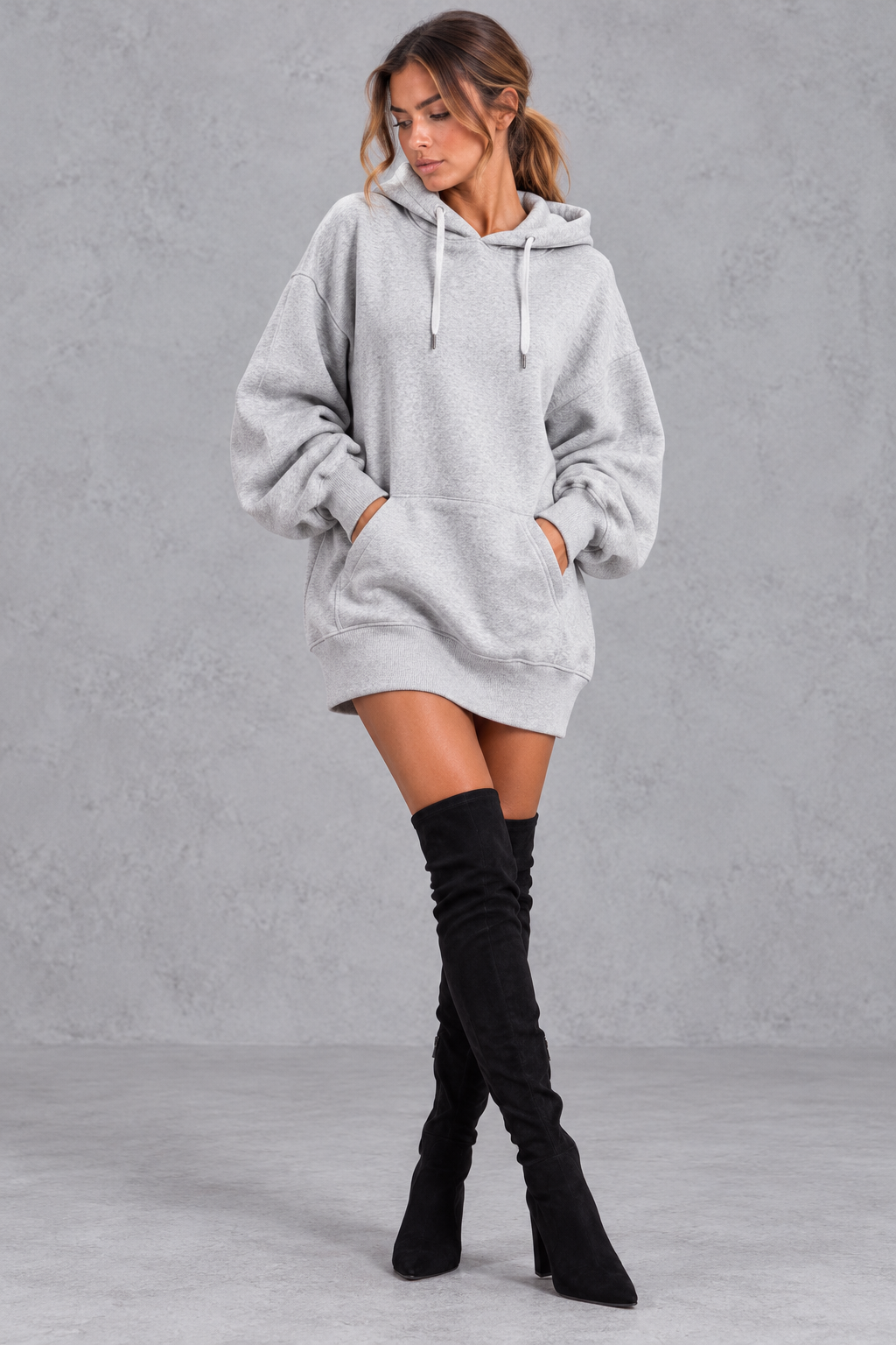 Women's grey oversized hoodie mini dress with drawstring hood and kangaroo pocket – front view