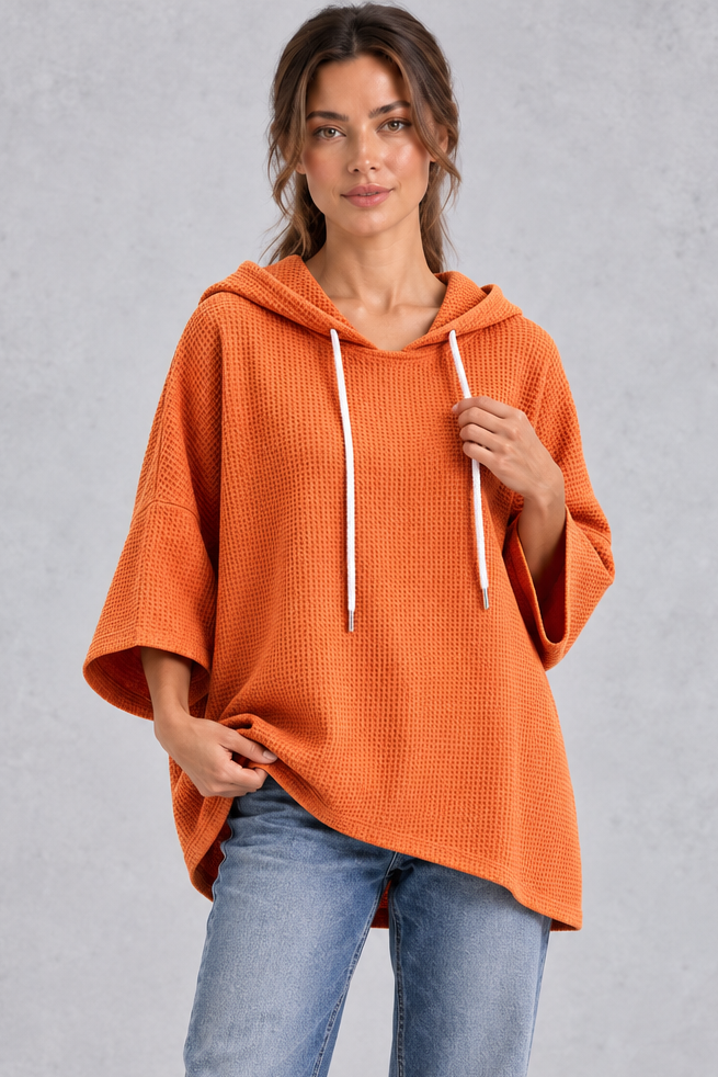 Women's plus size orange waffle knit oversized hoodie with drawstring hood and wide sleeves – front view