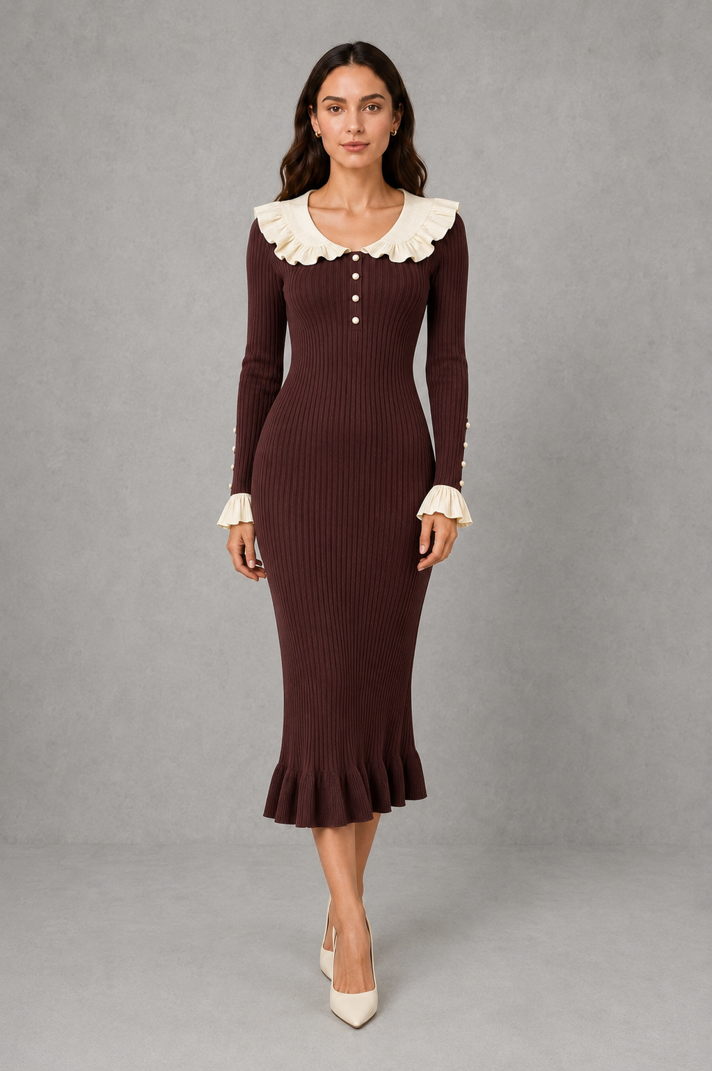 Women’s ribbed knit midi dress with a statement ruffle collar, decorative front buttons, fitted silhouette, long sleeves and flared ruffle cuffs.