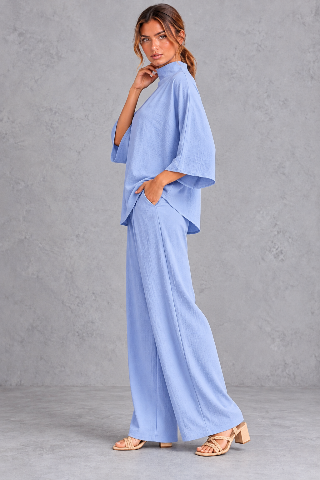 Women's blue turtleneck blouse and wide leg trouser co-ord set – side view showing trouser pocket