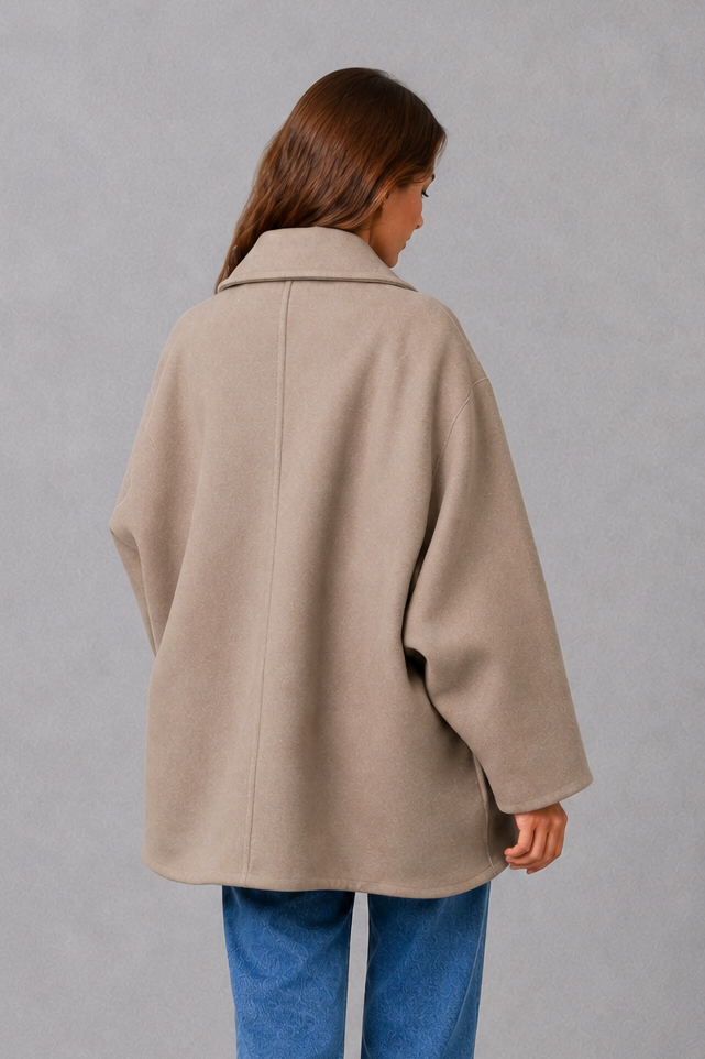 Women’s vintage casual longline coat with a relaxed silhouette, practical front pockets and timeless retro-inspired styling for cooler weather.