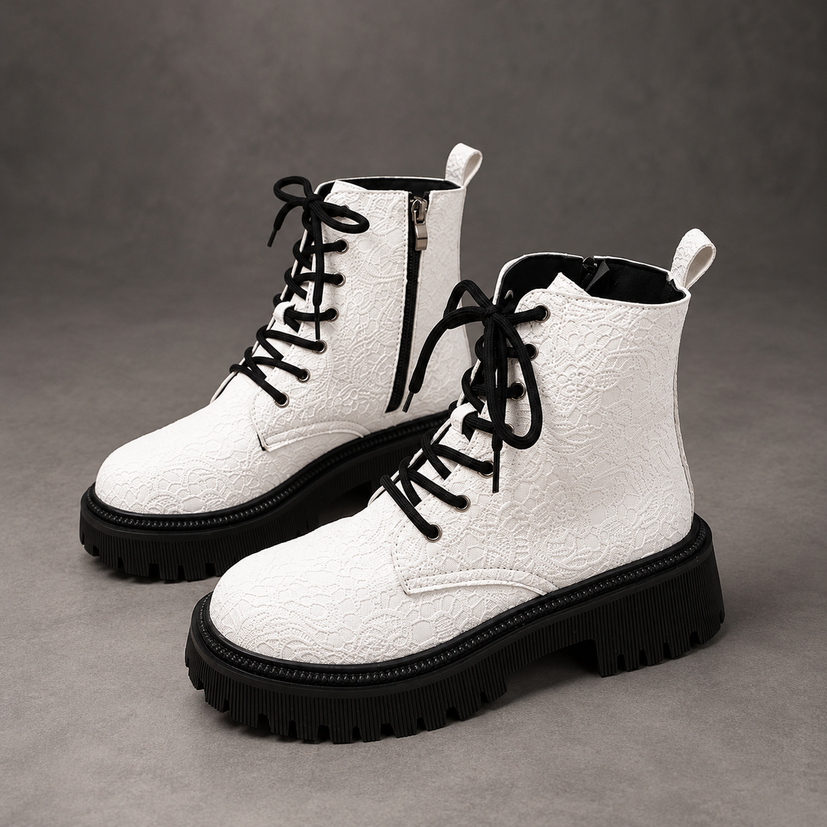 Women’s white embroidered ankle boots with a smooth PU leather upper, decorative embroidery, chunky platform heels and a structured combat-inspired silhouette.