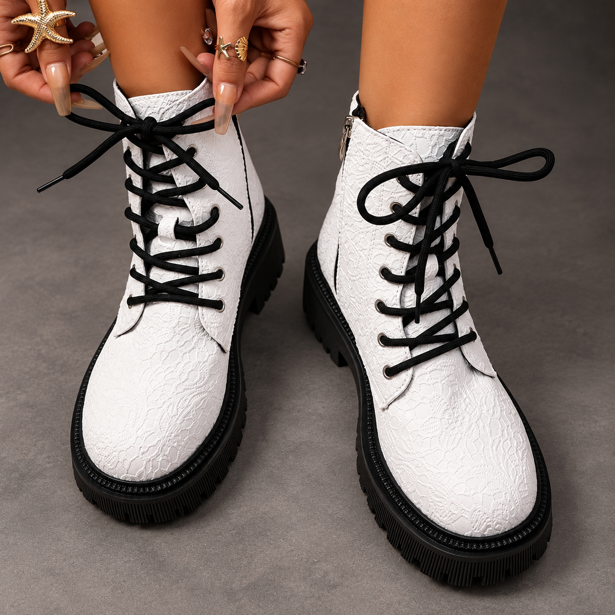 Women’s white embroidered ankle boots with a smooth PU leather upper, decorative embroidery, chunky platform heels and a structured combat-inspired silhouette.