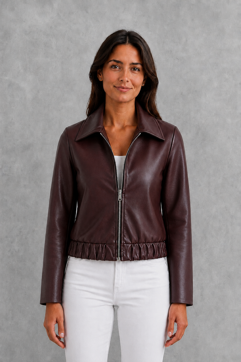 Women’s wine leather-look jacket with a tailored silhouette and front zip fastening, styled as an elegant biker-inspired autumn jacket.