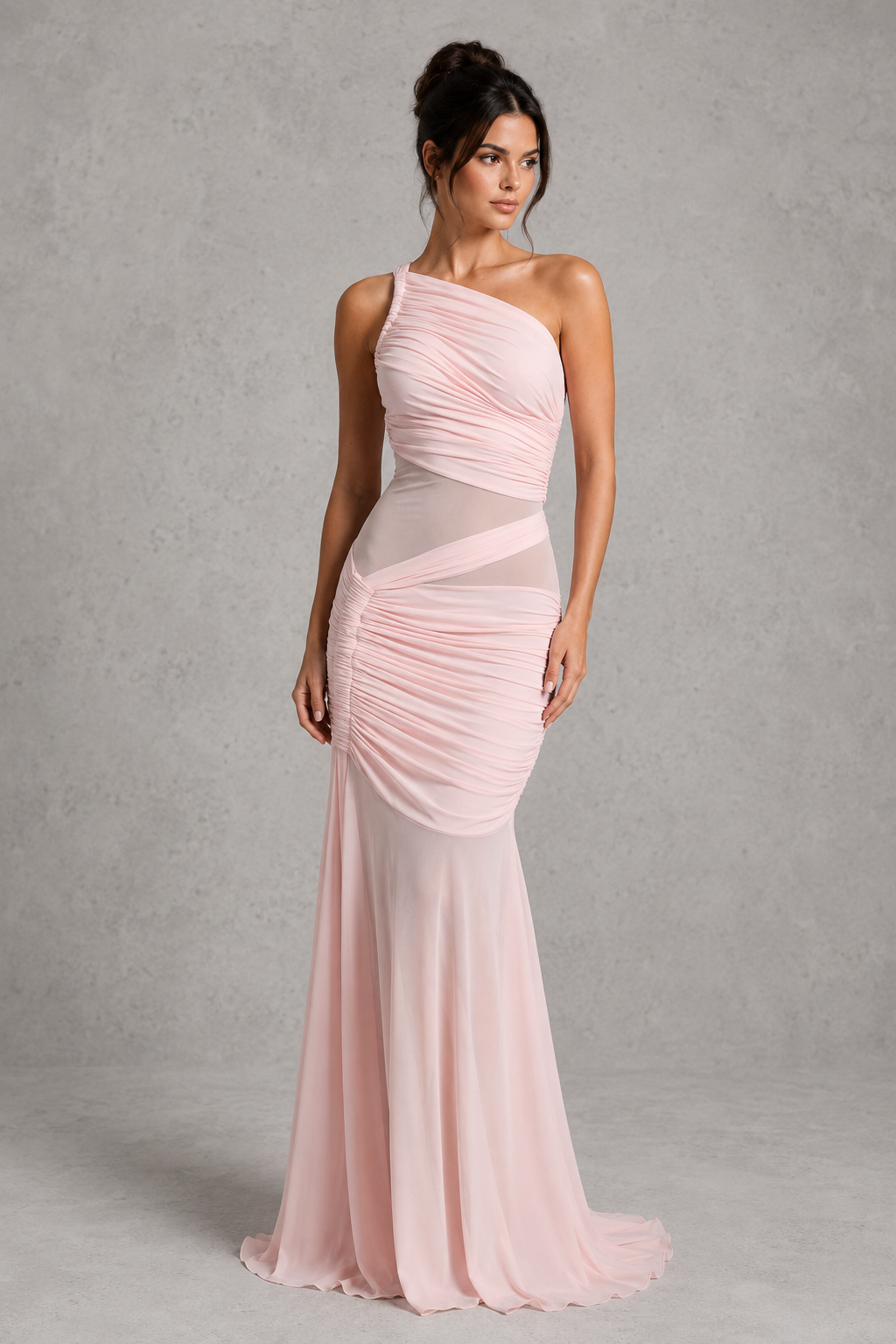 Woman wearing a pink one-shoulder gown against a gray background