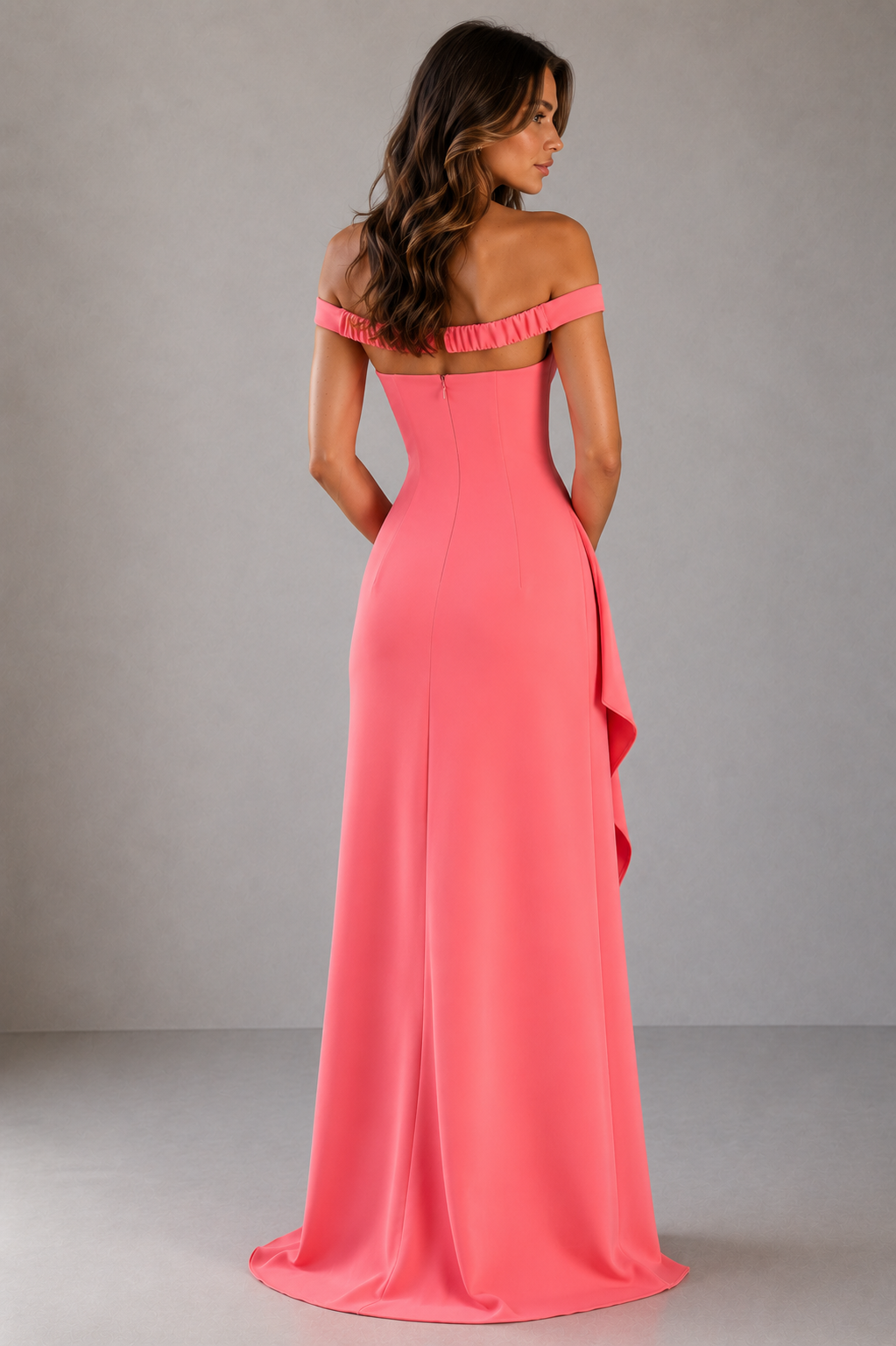 Woman wearing a pink off-shoulder gown against a gray background