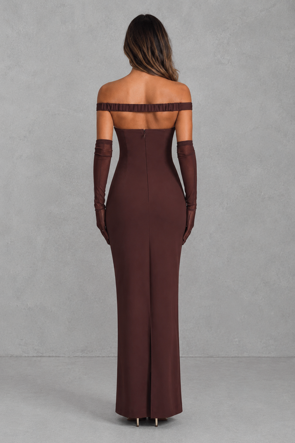 Brown off-shoulder evening gown with long gloves on a gray background
