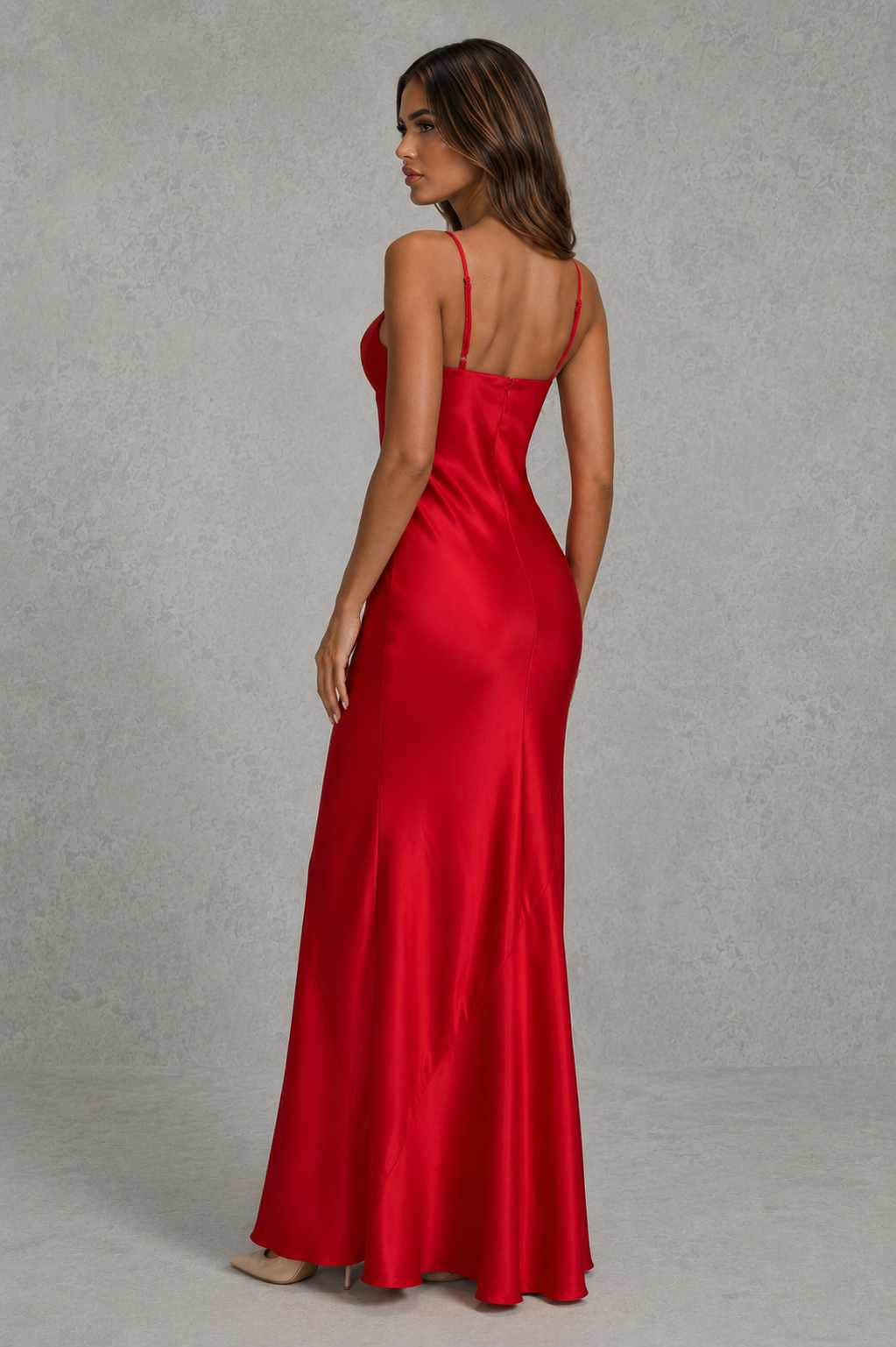 Woman wearing a red satin dress against a gray background