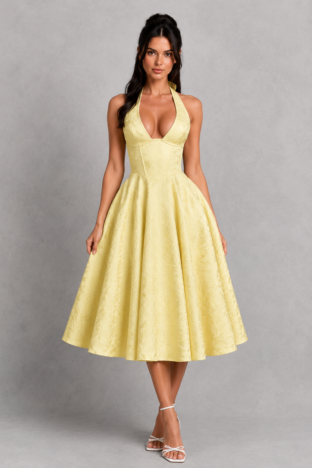 Woman wearing a yellow dress against a gray background