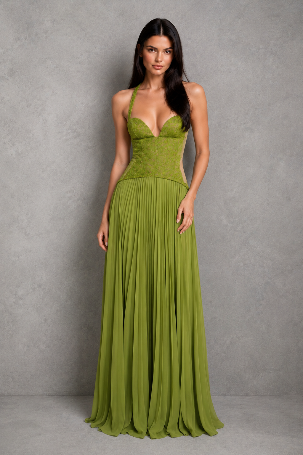Woman wearing a green evening gown against a gray background
