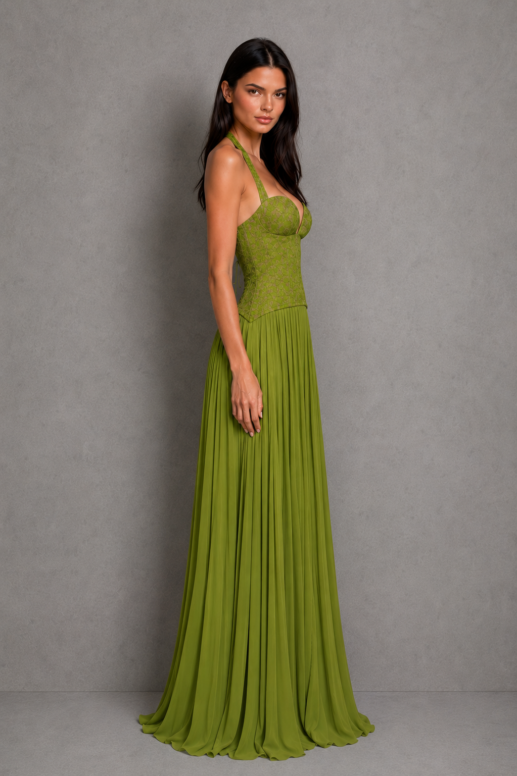 Woman wearing a green evening gown against a gray background