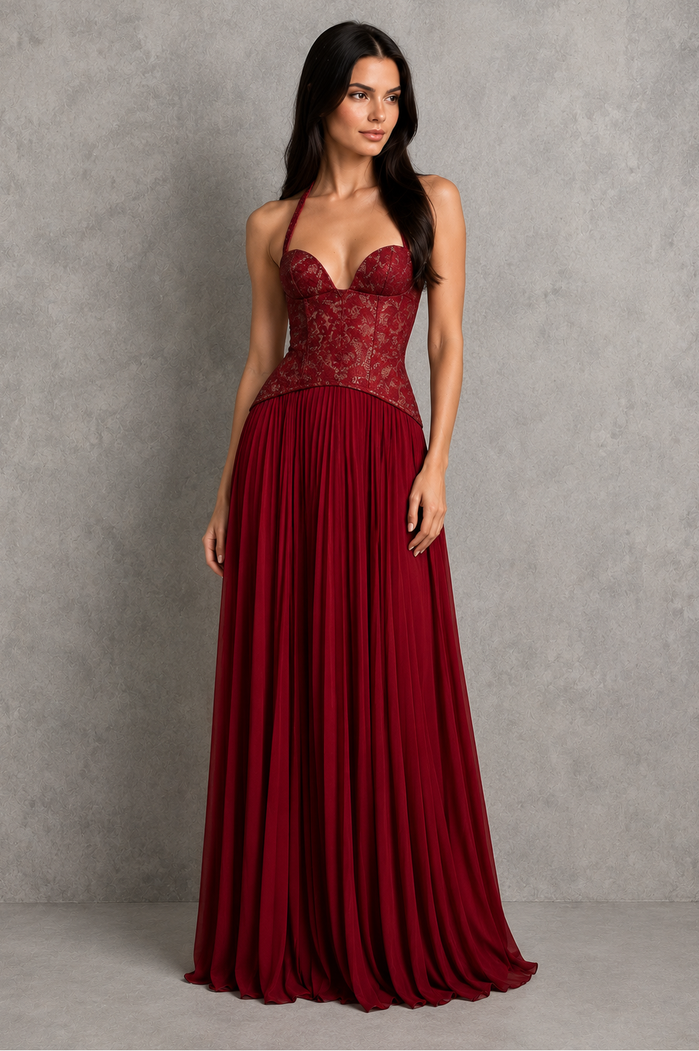 Woman wearing a burgundy evening gown against a gray background