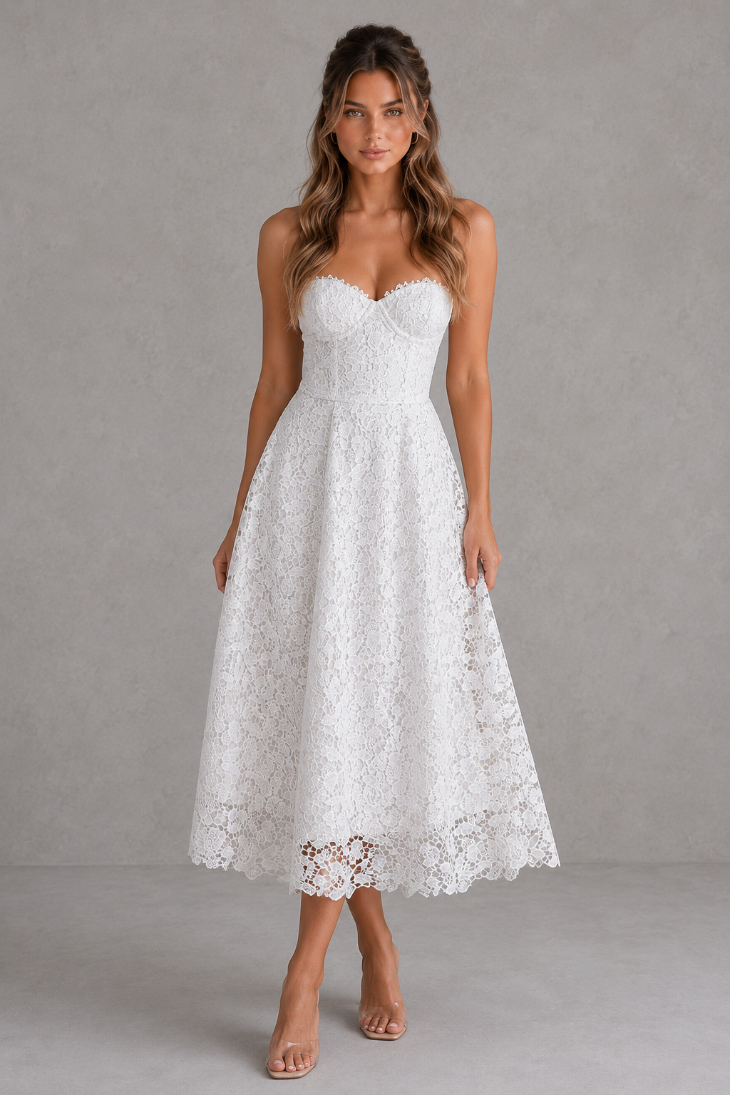 Woman wearing a white lace dress against a gray background