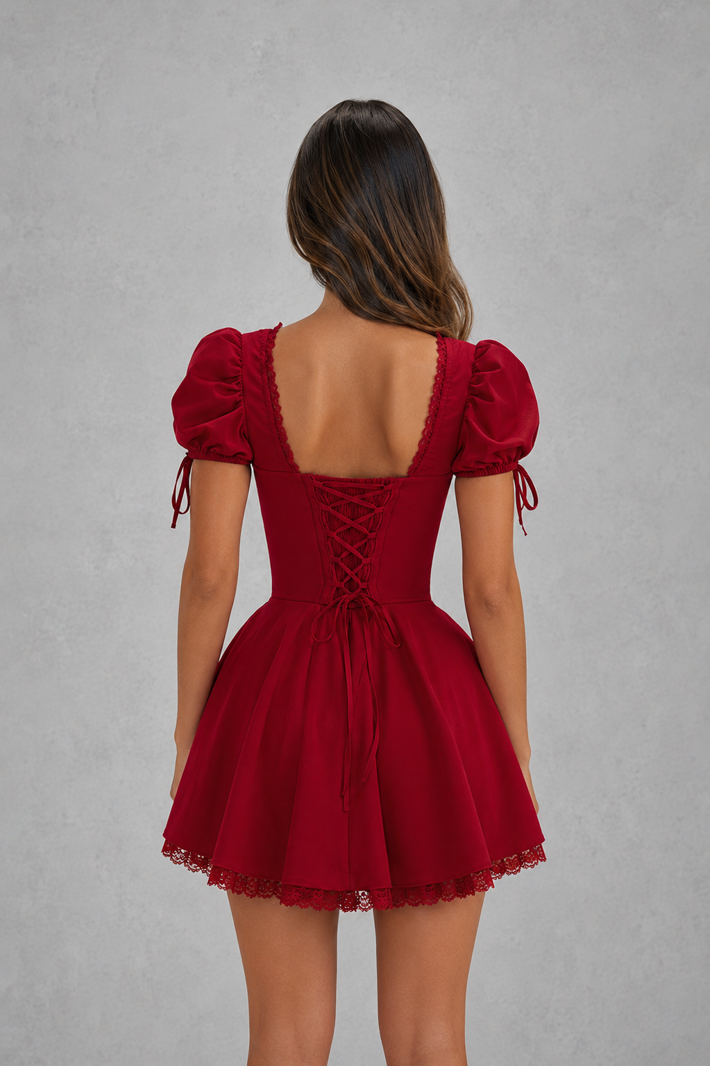 Red dress with puff sleeves and lace-up back on a gray background
