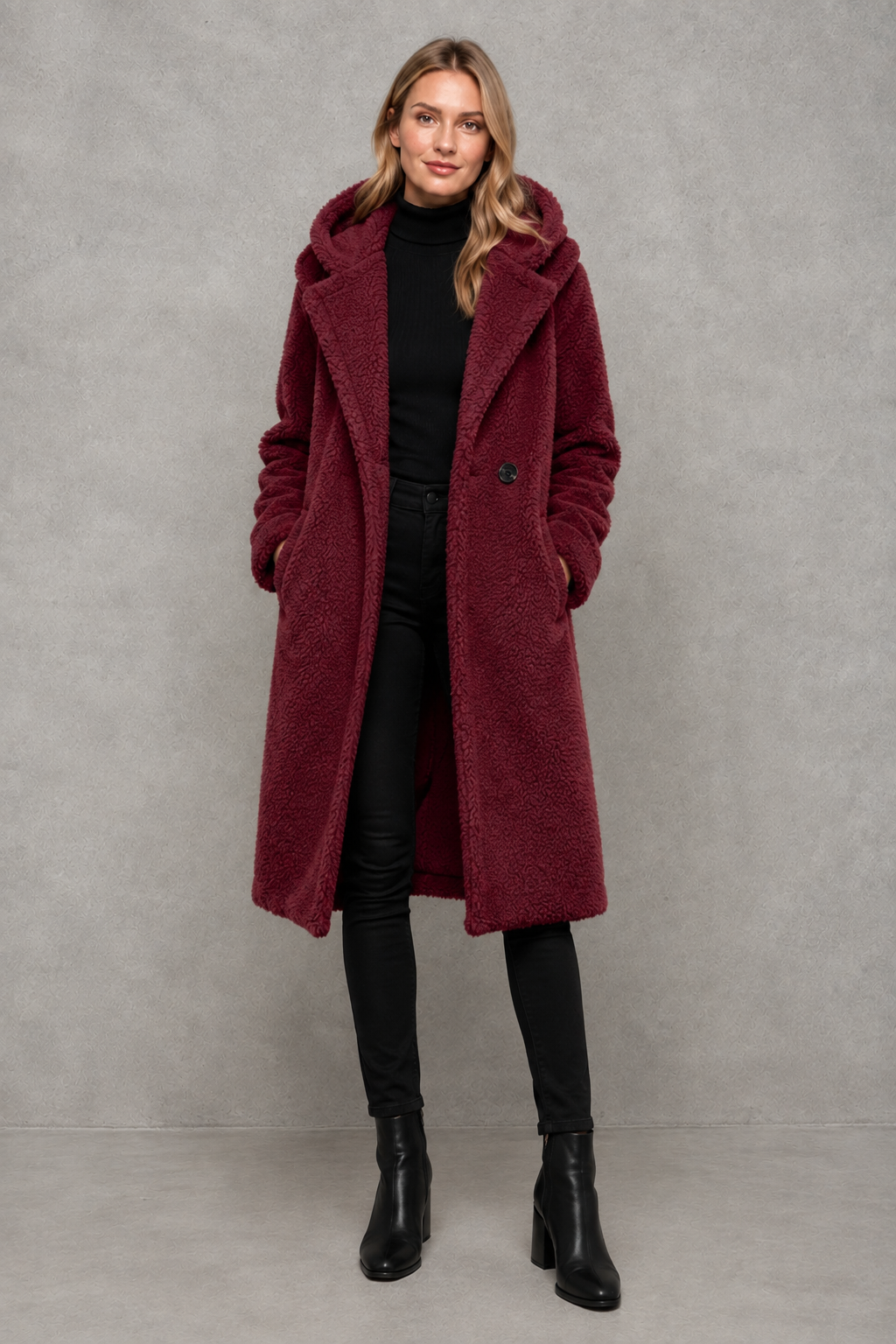 Women's quilted longline coat with a padded design, protective hood, deep side pockets and a relaxed fit, offering warm, lightweight comfort for autumn and winter wear.