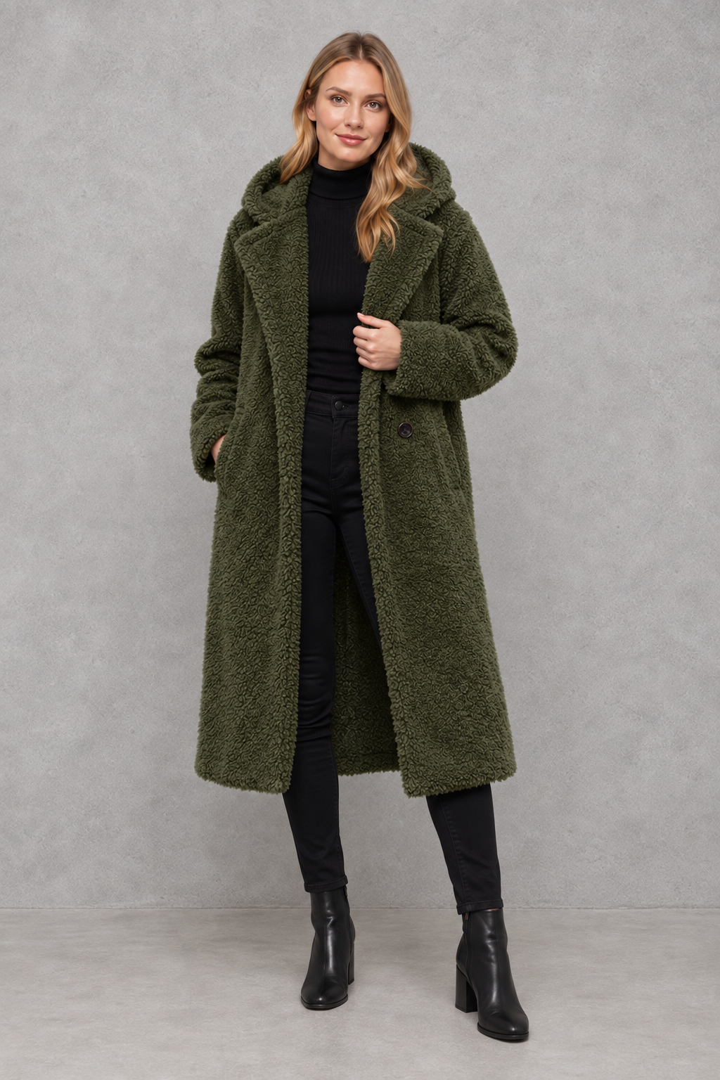 Women's quilted longline coat with a padded design, protective hood, deep side pockets and a relaxed fit, offering warm, lightweight comfort for autumn and winter wear.
