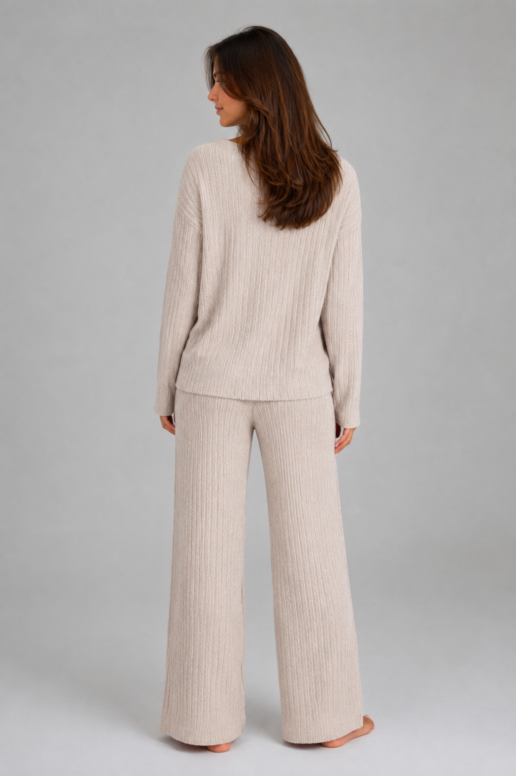 Women's ribbed knit lounge set featuring a relaxed V-neck jumper and matching wide leg trousers in a soft stretch knit, designed for cosy everyday comfort and casual wear.