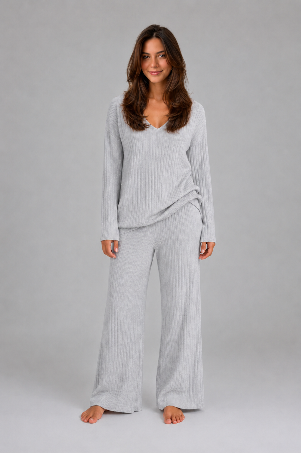 Women's ribbed knit lounge set featuring a relaxed V-neck jumper and matching wide leg trousers in a soft stretch knit, designed for cosy everyday comfort and casual wear.