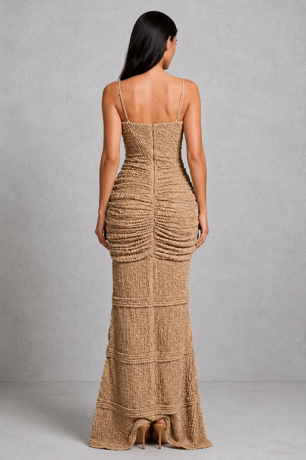 Woman wearing a brown textured dress against a gray background