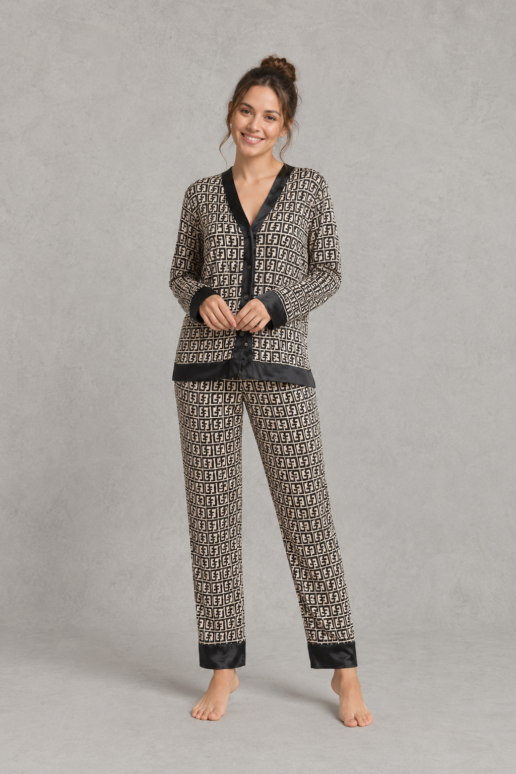 Women's brown satin two-piece pyjama set with a geometric print, long sleeve button-up V-neck top and matching full-length trousers.