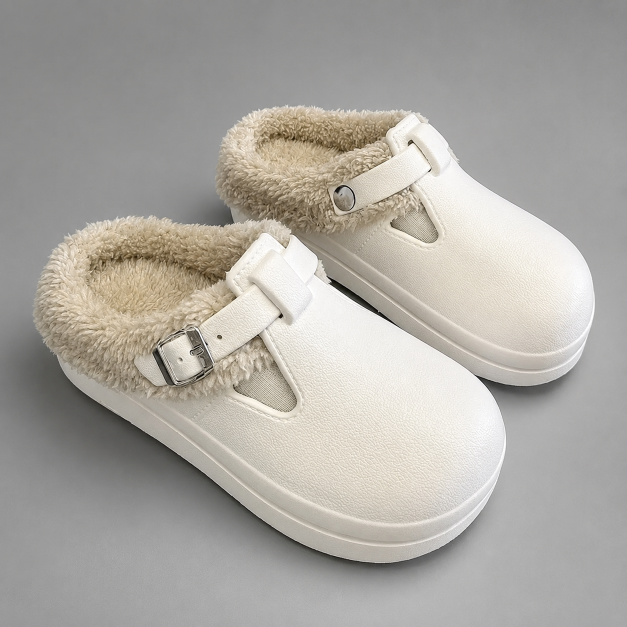 Women's waterproof fur-lined mule slippers with a thick non-slip sole, plush faux fur lining, metal buckle detail and lightweight slip-on design for warm indoor comfort during autumn and winter.