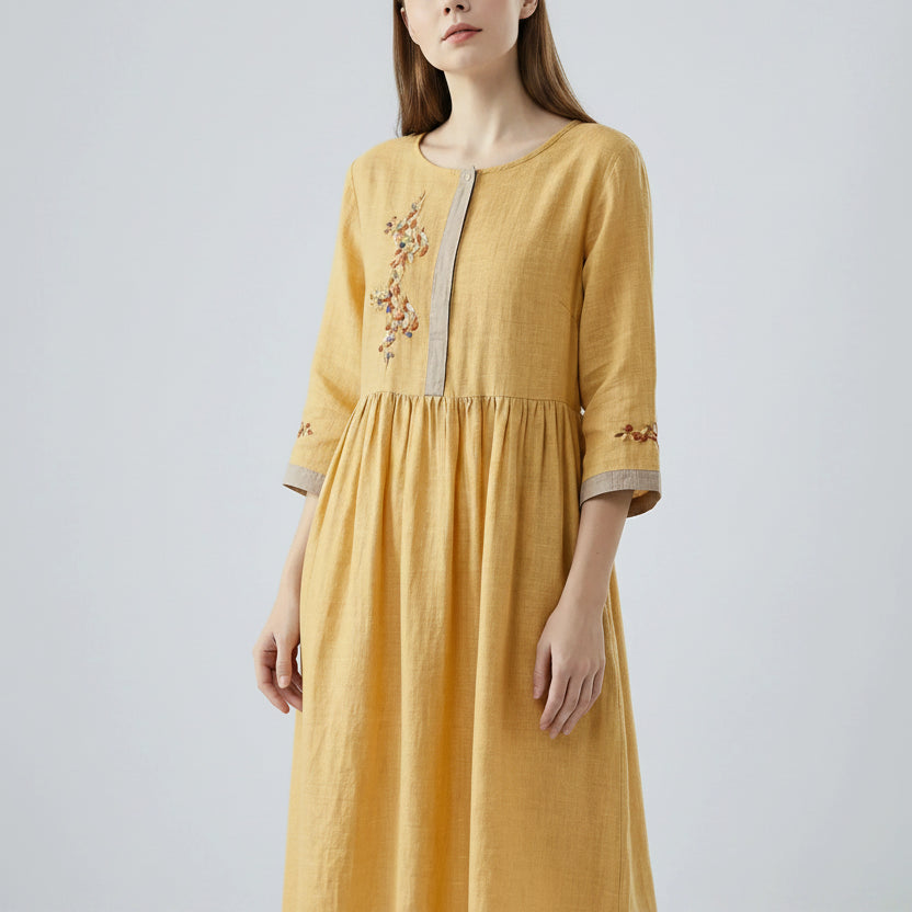 Yellow dress with embroidery on a white background