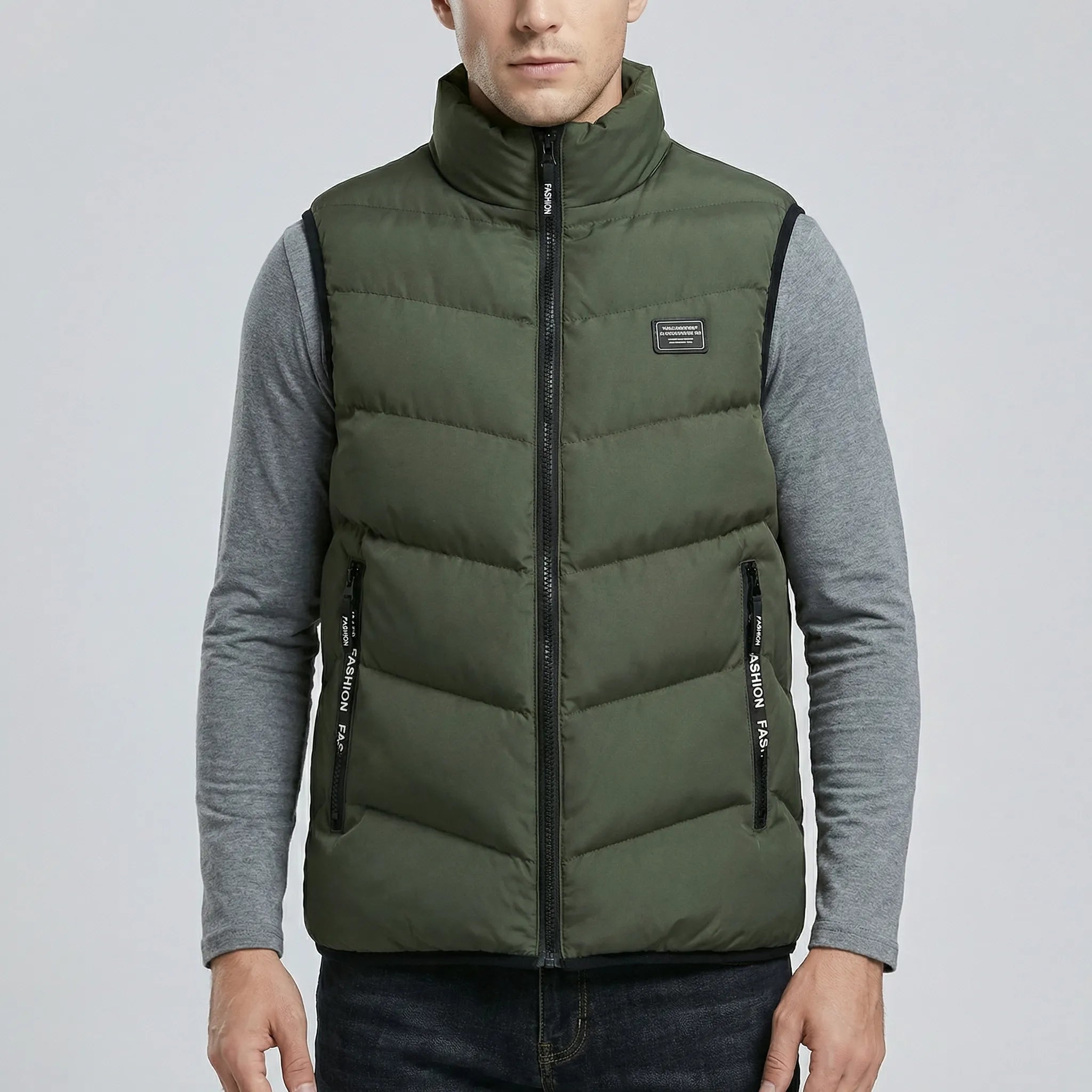 Person wearing a green puffer vest over a gray shirt on a light gray background
