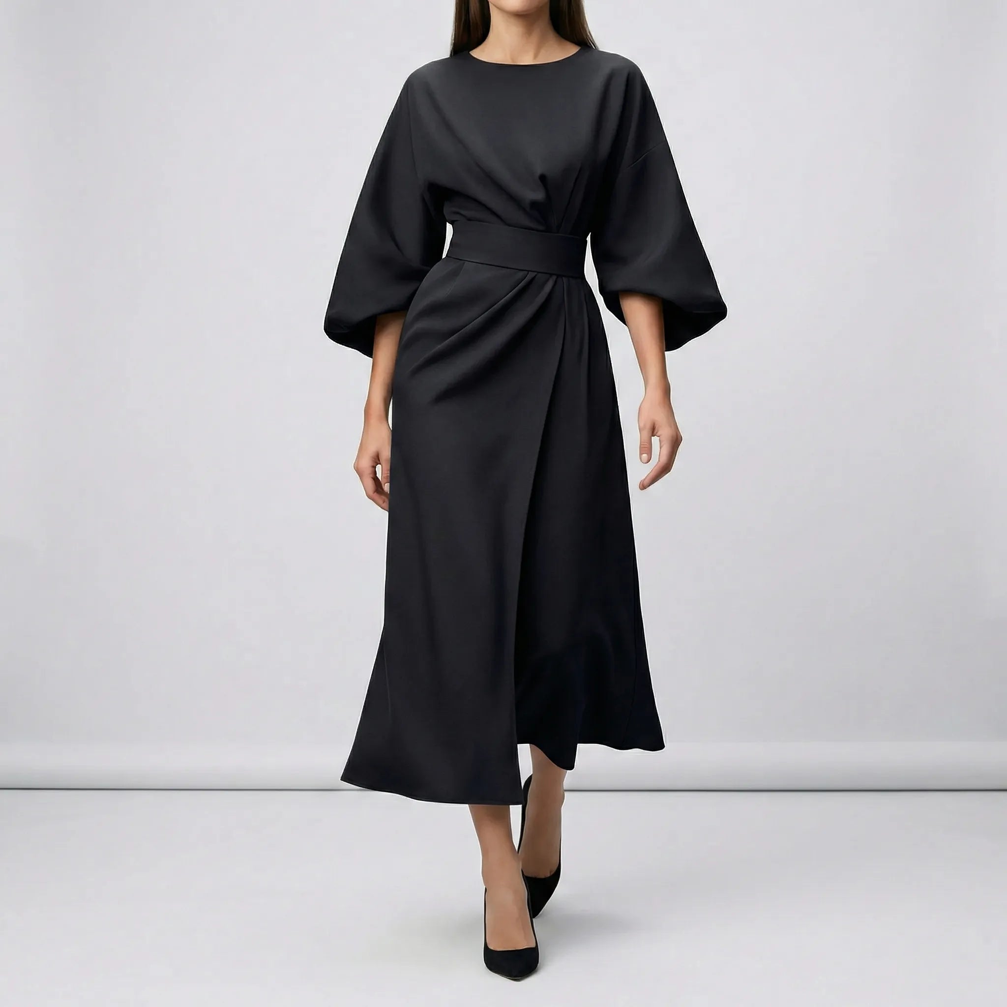 Black dress with wide sleeves on a plain background