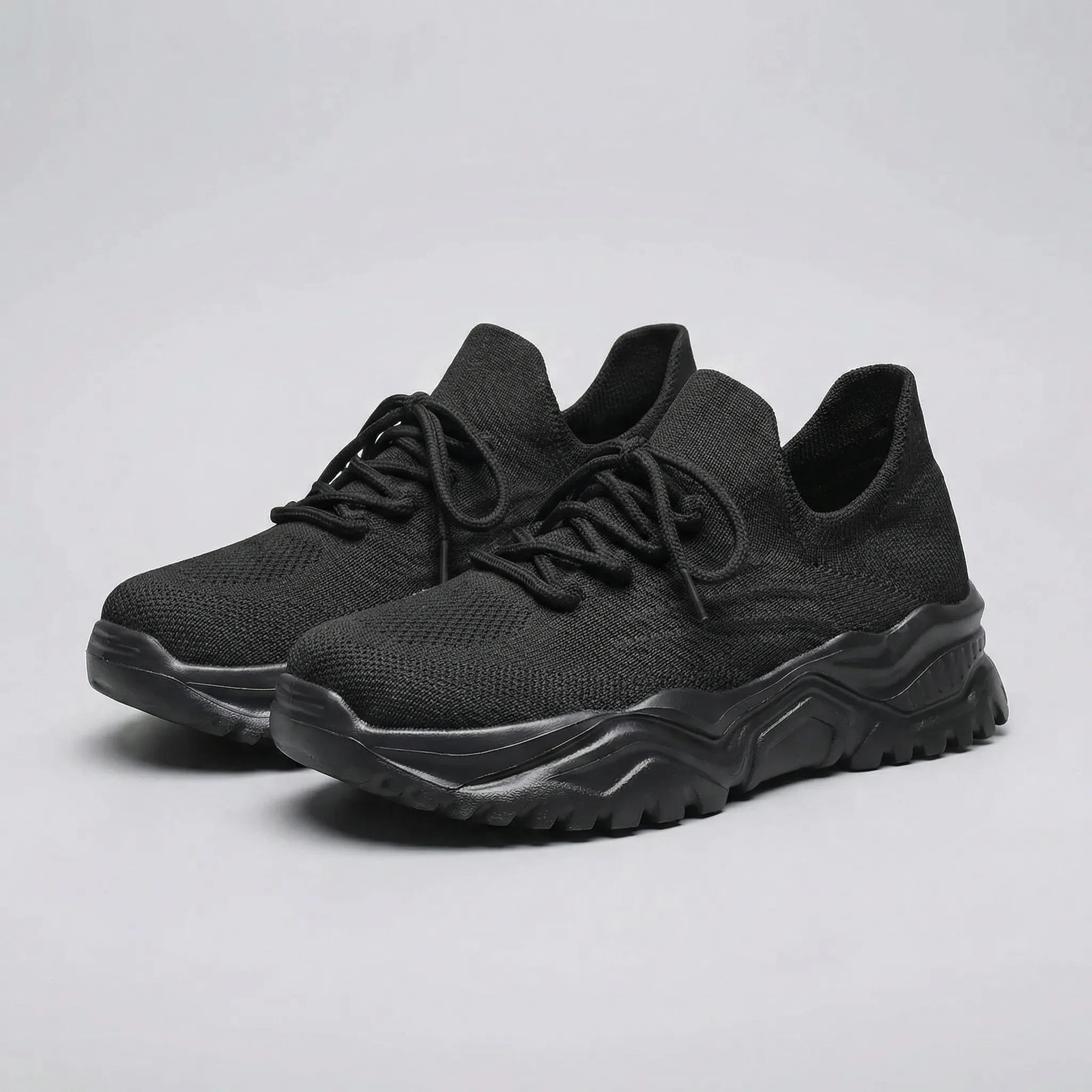 Black running shoes on a white background